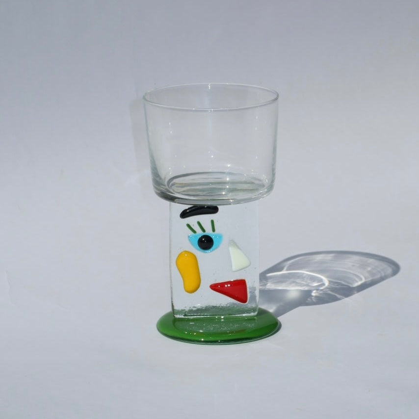 Clear glass with colorful design on a gray background