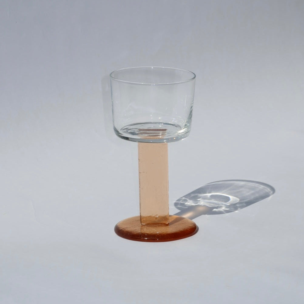 Clear glass with pink base on a gray background